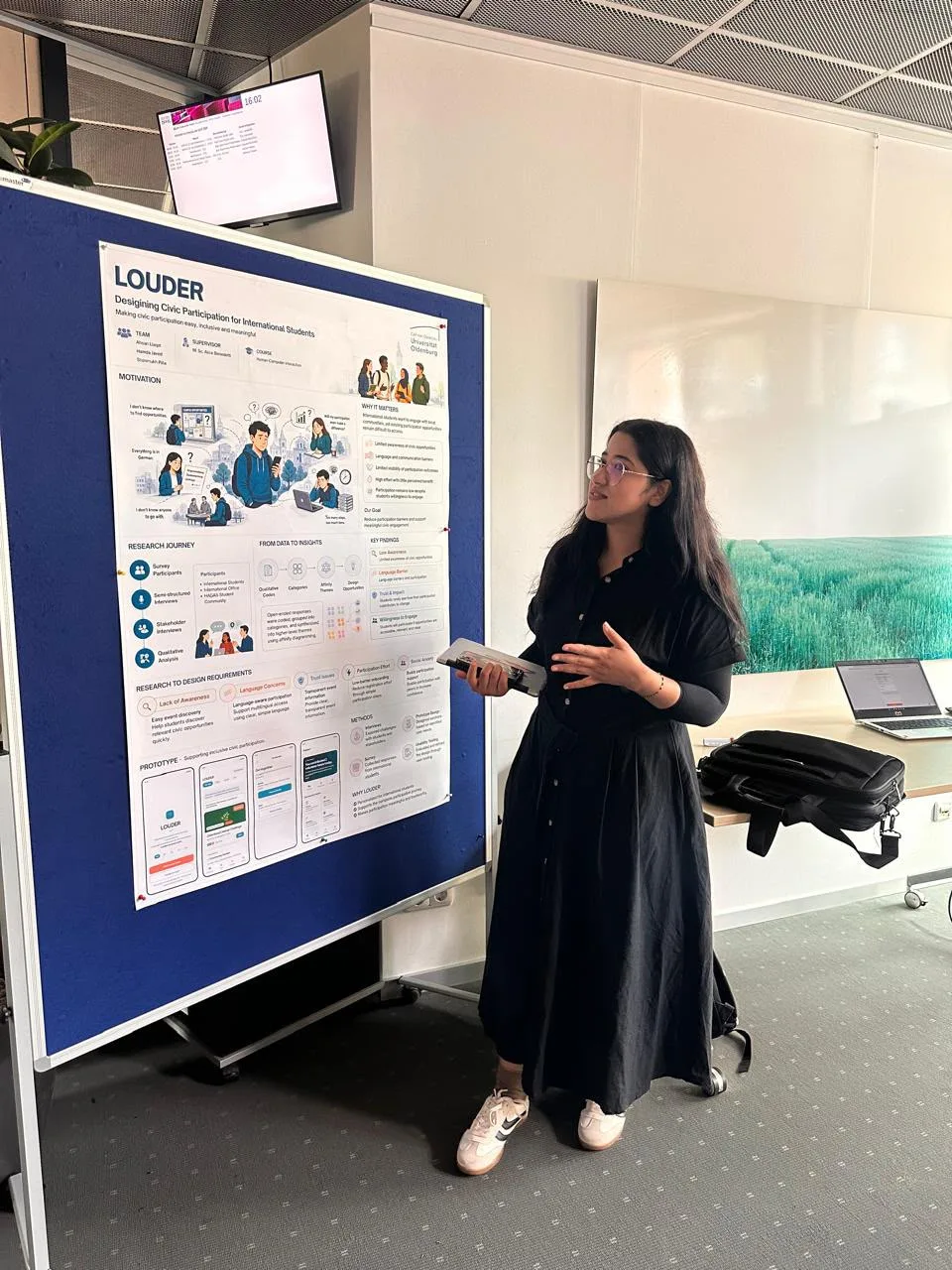 Hamda presenting the Louder research poster at the university poster session.